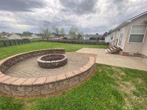 view of yard featuring a fire pit and a patio