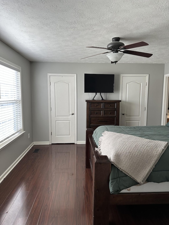 bedroom with ceiling fan and dark hardwood / wood-style flooring