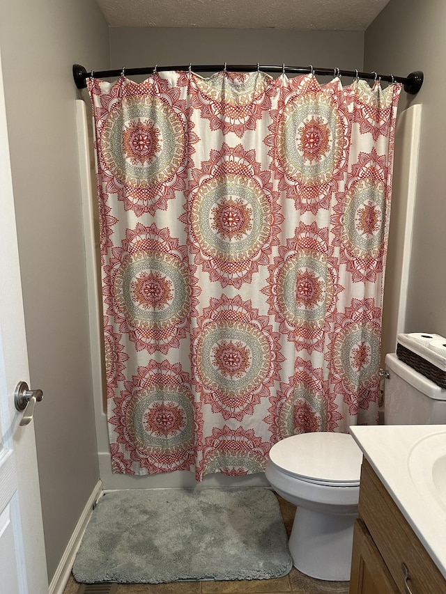 bathroom with tile patterned flooring, vanity, and toilet