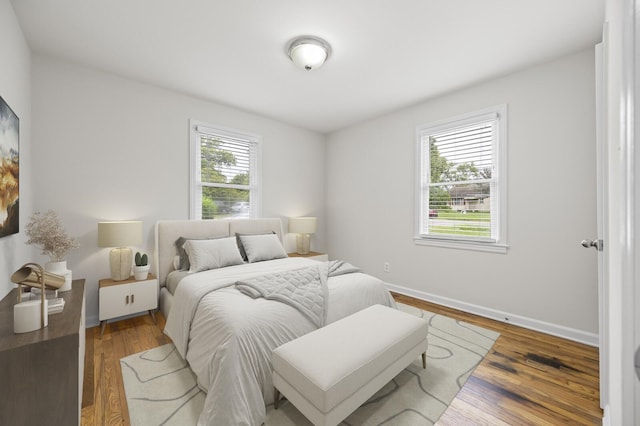 bedroom featuring hardwood / wood-style floors and multiple windows