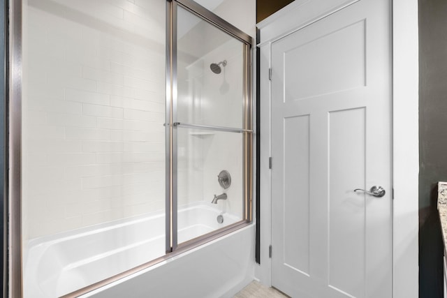 bathroom with shower / bath combination with glass door