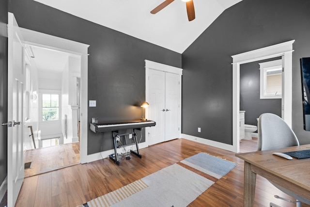 home office with hardwood / wood-style floors, ceiling fan, and lofted ceiling