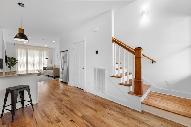 staircase featuring hardwood / wood-style floors