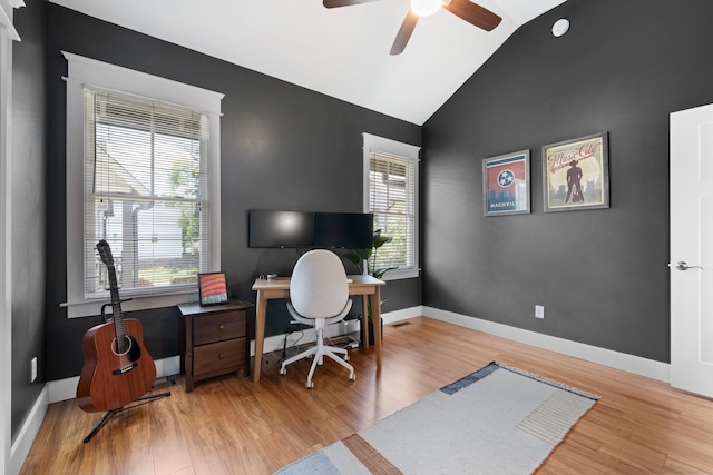 home office featuring ceiling fan, vaulted ceiling, and light hardwood / wood-style flooring