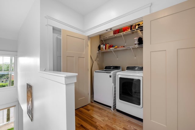 laundry room featuring wood-type flooring and washing machine and clothes dryer