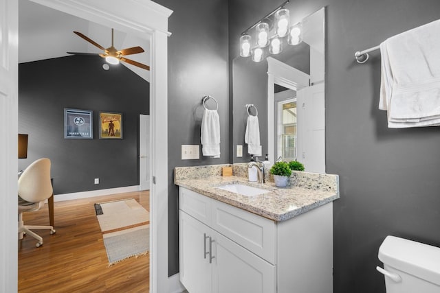 bathroom with ceiling fan, hardwood / wood-style floors, vanity, and toilet