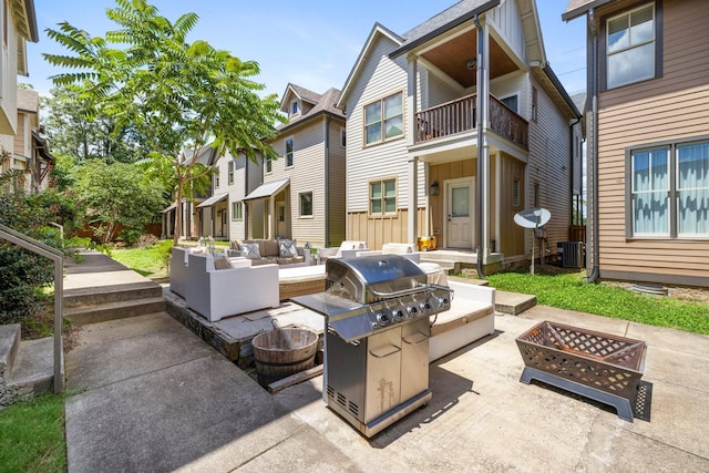 view of patio with central AC, area for grilling, and an outdoor living space with a fire pit