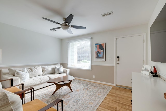 living room featuring light wood-type flooring and ceiling fan