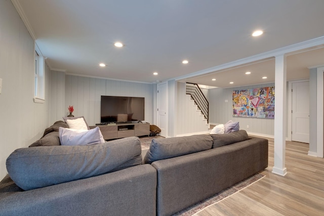 living room with light hardwood / wood-style floors and ornamental molding