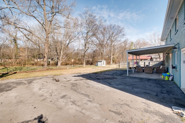 view of yard with a storage unit and a carport