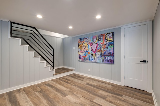 interior space featuring hardwood / wood-style floors and crown molding