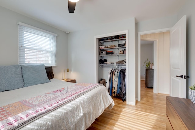 bedroom with light wood-type flooring, a closet, and ceiling fan