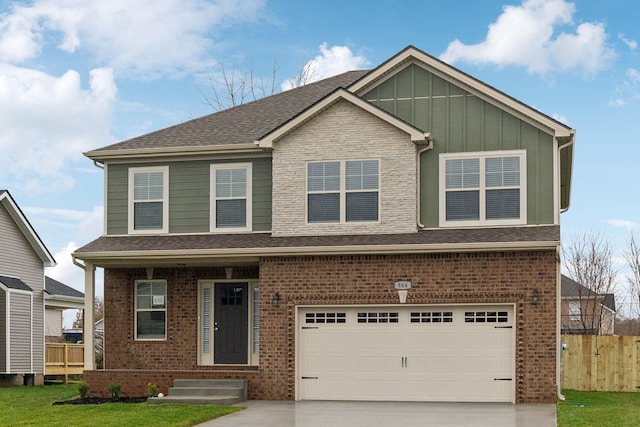 craftsman-style home featuring a garage and a front lawn