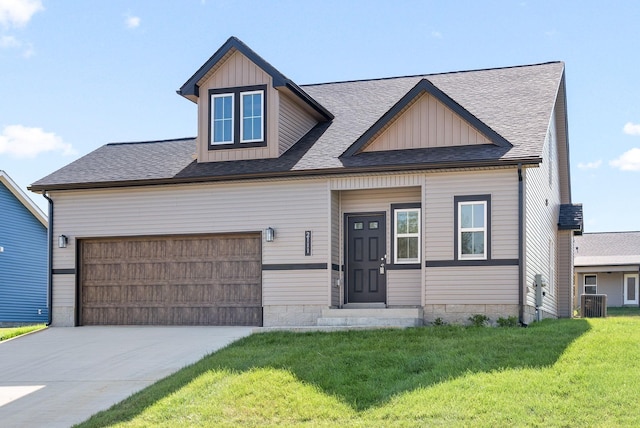 view of front of house featuring central air condition unit, a front lawn, and a garage