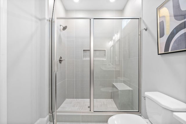 bathroom with walk in shower and toilet