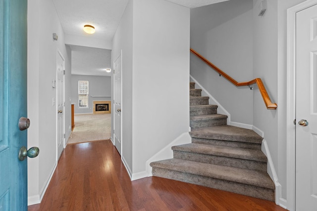 entrance foyer featuring dark hardwood / wood-style floors and a textured ceiling