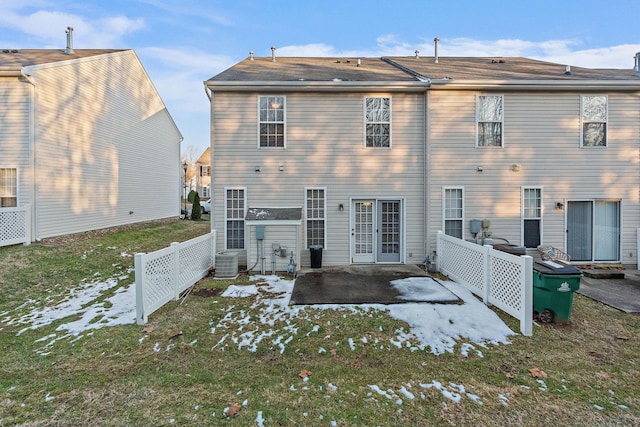 back of property featuring a patio area, a yard, and central AC