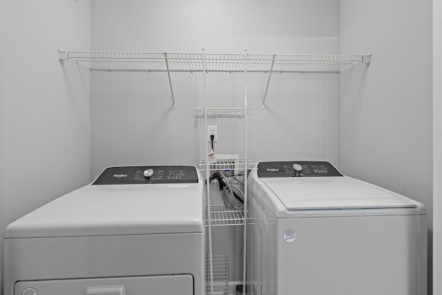 clothes washing area featuring independent washer and dryer