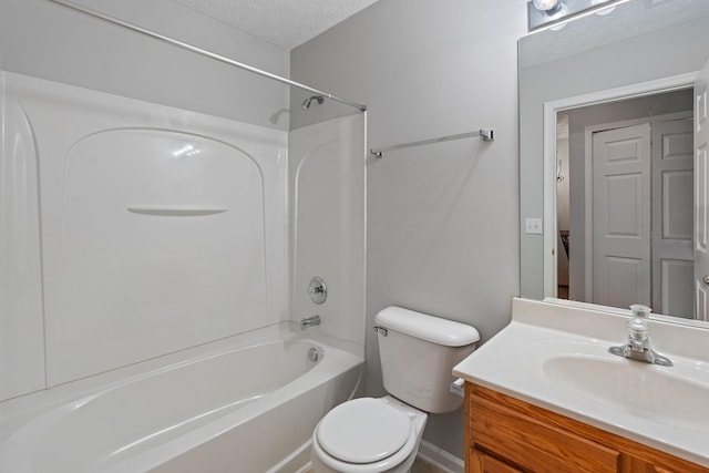 full bathroom featuring vanity, a textured ceiling, toilet, and washtub / shower combination