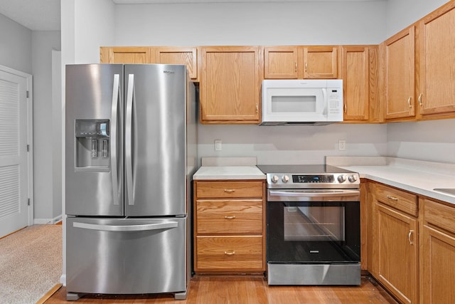 kitchen featuring light brown cabinetry and appliances with stainless steel finishes