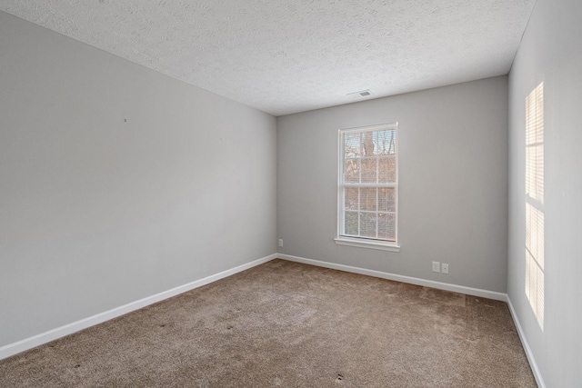 spare room with carpet and a textured ceiling