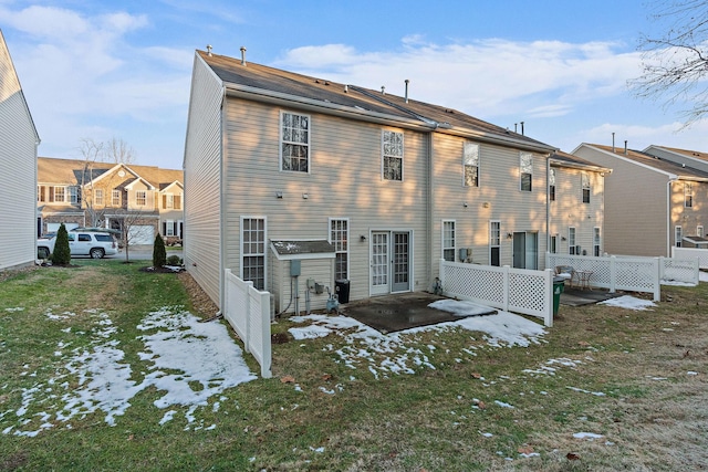 snow covered property with a lawn