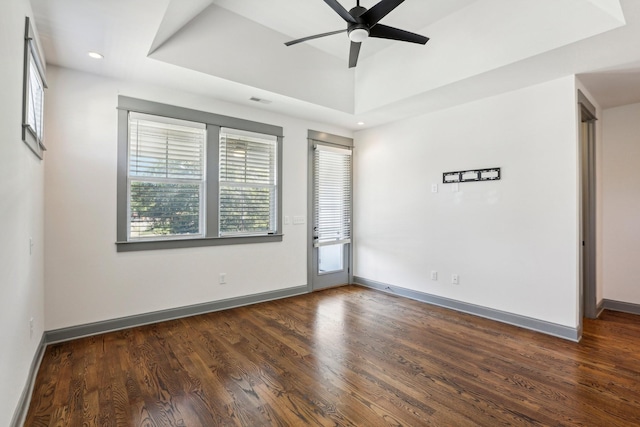 empty room with ceiling fan and dark wood-type flooring