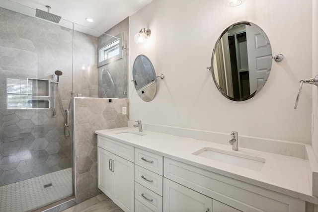 bathroom featuring vanity, tiled shower, and tile walls