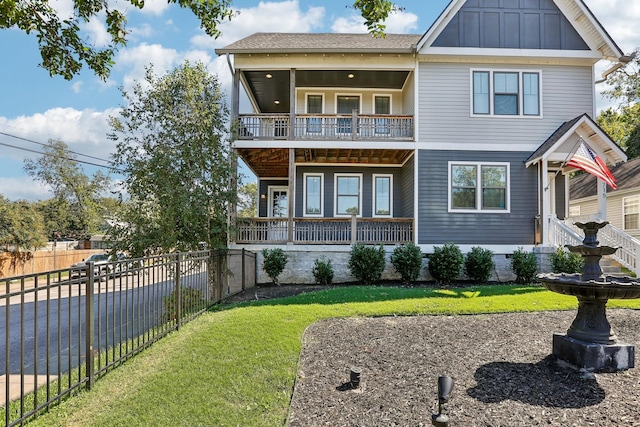 view of front of home featuring a front yard and a balcony