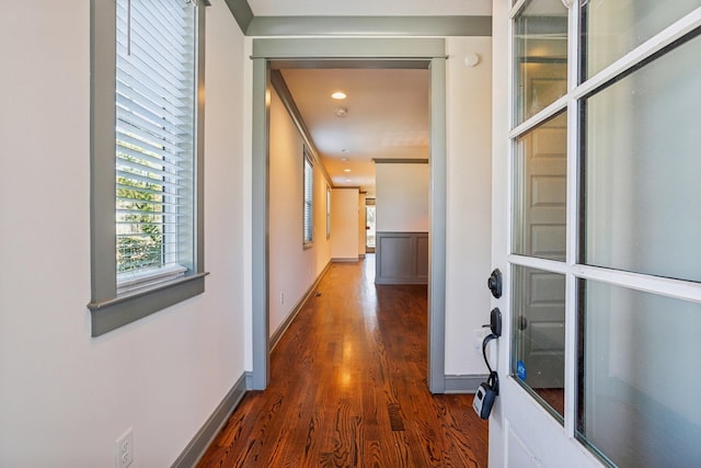 corridor with dark hardwood / wood-style floors