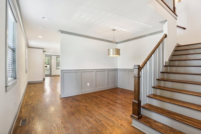 staircase featuring wood-type flooring