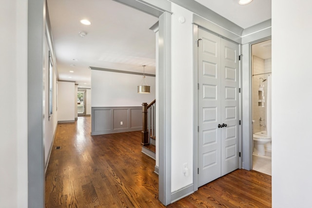 corridor with dark hardwood / wood-style flooring