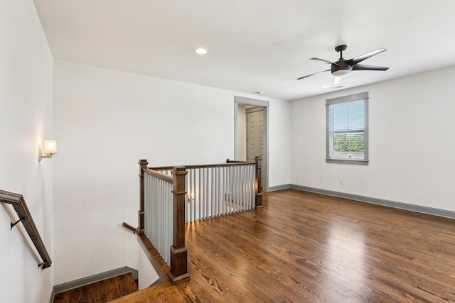 unfurnished room featuring dark hardwood / wood-style flooring and ceiling fan