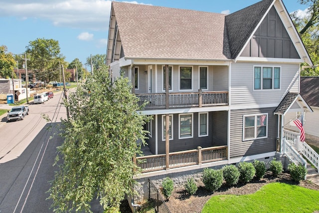 view of front of property with a porch and a balcony