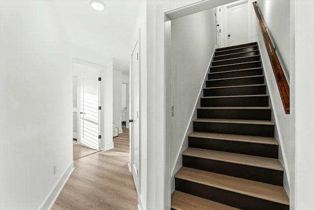 stairs with hardwood / wood-style flooring