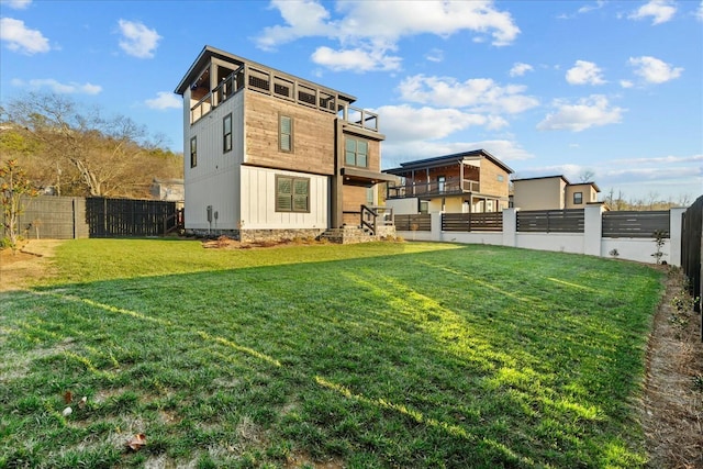 back of house with a lawn