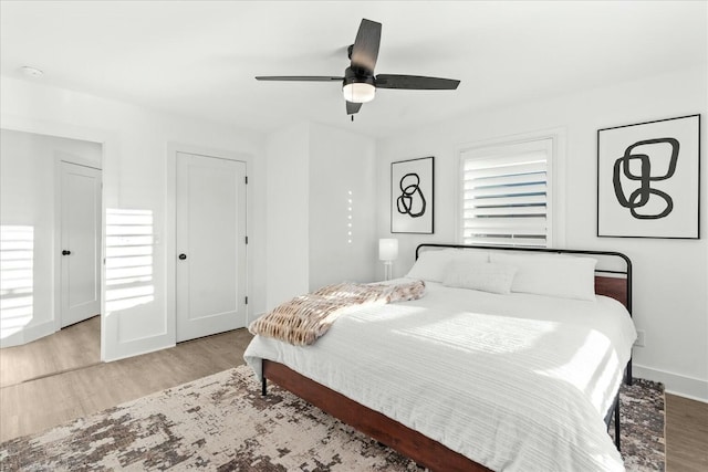 bedroom featuring ceiling fan and light hardwood / wood-style flooring