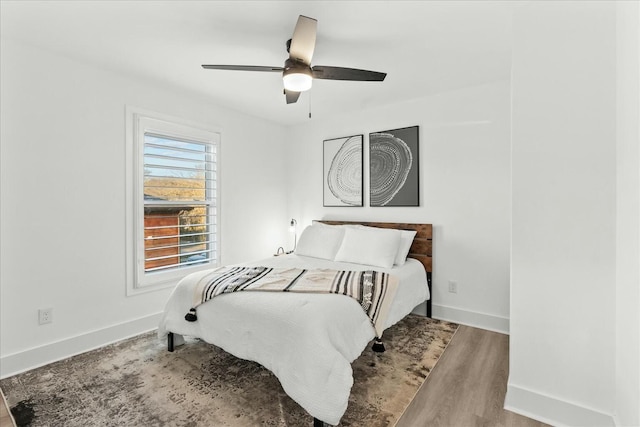 bedroom with light hardwood / wood-style floors and ceiling fan