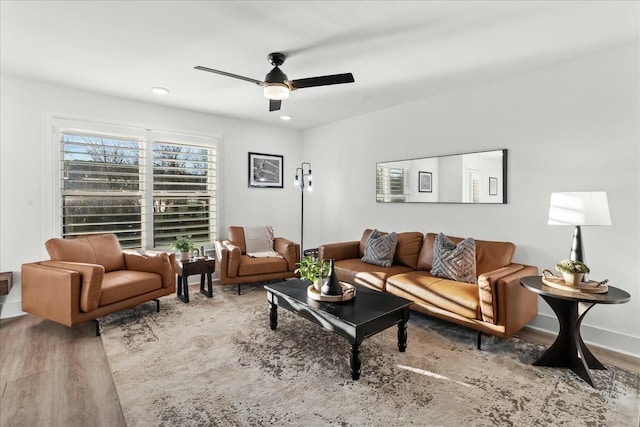 living room featuring hardwood / wood-style floors and ceiling fan