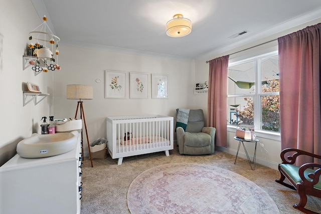 carpeted bedroom featuring a crib and ornamental molding