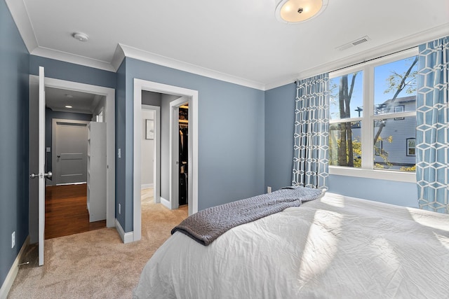 bedroom featuring light colored carpet and ornamental molding