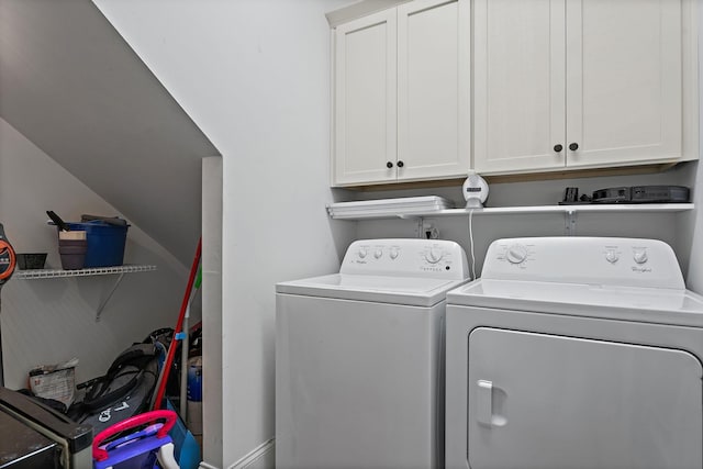 laundry room with cabinets and washer and clothes dryer