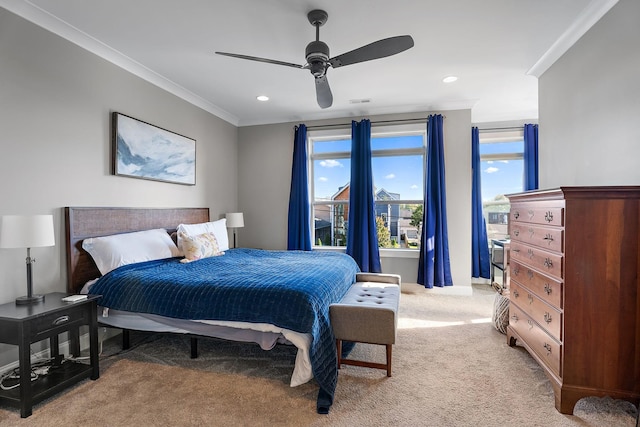 carpeted bedroom featuring ceiling fan and crown molding