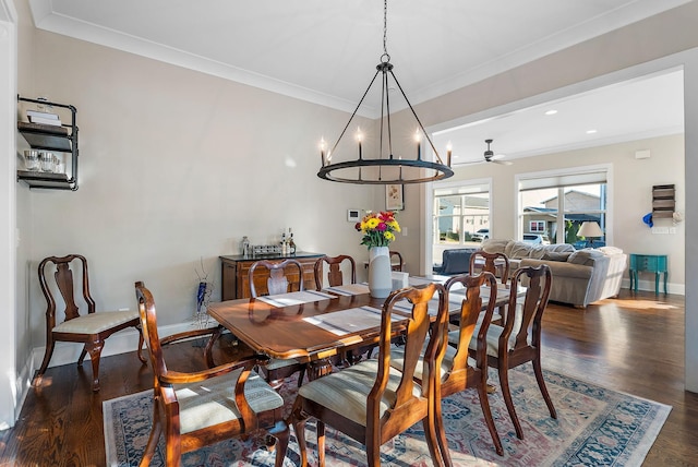 dining room with ceiling fan with notable chandelier, dark hardwood / wood-style floors, and crown molding