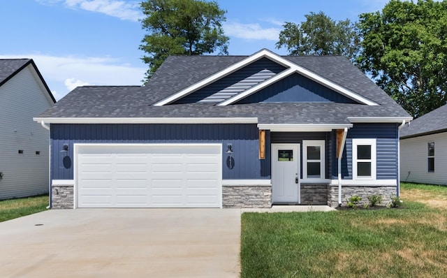 craftsman inspired home featuring a front yard and a garage