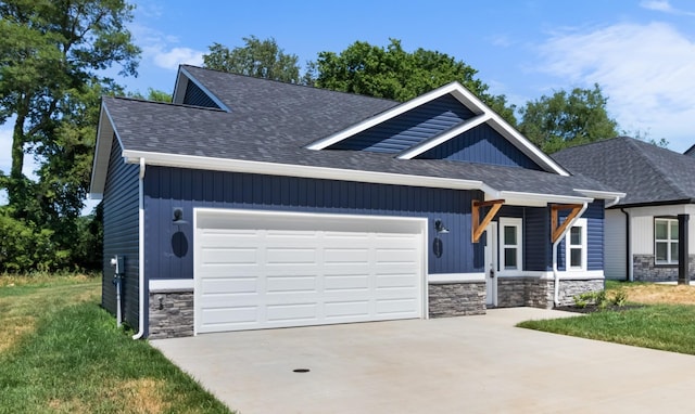 craftsman-style home featuring a garage and a front yard