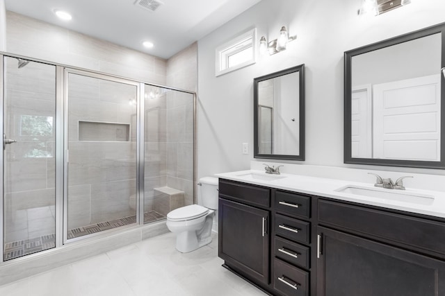 bathroom featuring tile patterned floors, vanity, toilet, and walk in shower