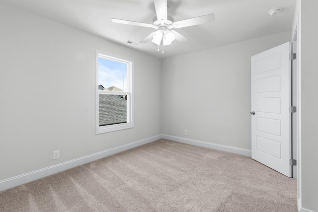 carpeted spare room with ceiling fan