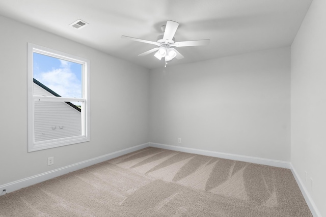 spare room with carpet floors and ceiling fan