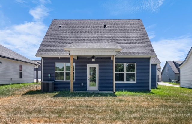 back of house featuring a lawn, ceiling fan, and central AC unit